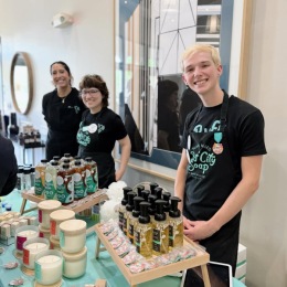 people with different soaps and candles on a table in front of them