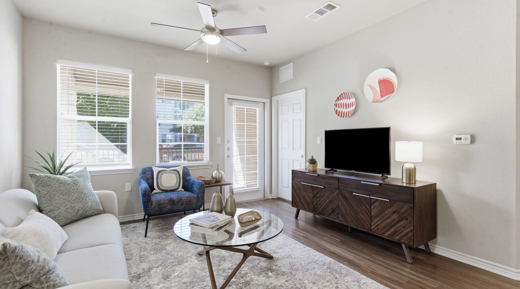 living room with tv couch windows and coffee table
