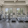 fitness room with equipment and on wood-style flooring